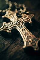 Close-up of a silver cross on a wooden table, shallow depth of field photo