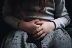 child hands holding on a sick stomach, stomach pain diarrhea photo