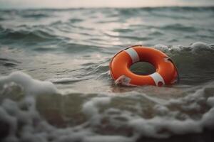 orange life buoy in the sea water photo
