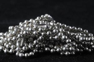 Silver beads on black background photo