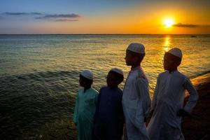 Bangladesh junio 22, 2019 algunos musulmán Niños son en pie por el orilla acecho el noche puesta de sol a Chandpur, bangladesh foto