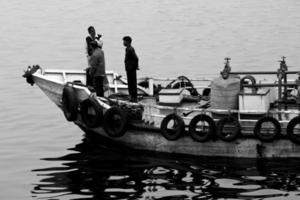 Bangladesh January 06, 2014 Heavy winter afternoon a Oil supply machine boat are passing at Buriganga River. photo