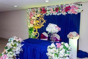 Artificial colorful paper flowers with navy-blue color based wedding stage decoration. photo
