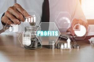 Profit growth, increase profit, raise profit or business growth concept, Businessman putting coin on glass jar with profits icon on virtual screen. photo
