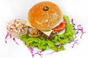 A big size Burger Patties from Ground Beef with Lettuce leaf and Coleslaw Salad. photo