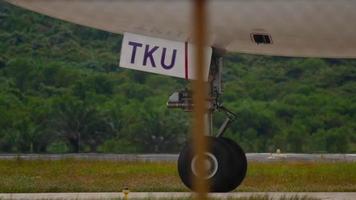 PHUKET, THAILAND DECEMBER 05, 2016 - Close sht of engine and chassis. View on airplane wheel at taxiing, close up shot video