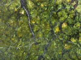 background from polished natural serpentinite rock photo