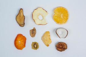 Dried fruits isolated on white background. Healthy eating concept. Top view. Healthy vegetarian food concept. Dried fruit chips. photo