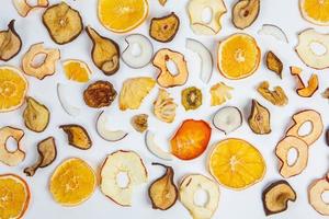 Dried fruits isolated on white background. Healthy eating concept. Top view. Healthy vegetarian food concept. Dried fruit chips. photo