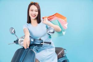 Young Asian woman on motorbike photo