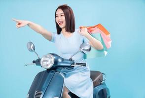 Young Asian woman on motorbike photo