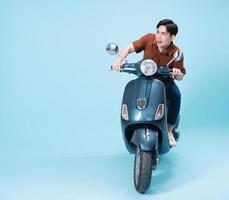 Image of yougn Asian man on motorbike photo