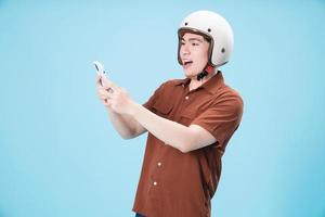 Young Asian man wearing helmet on background photo