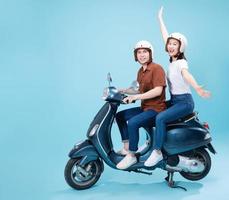 Young Asian couple ride scooter on background photo