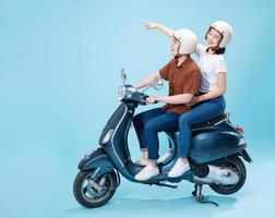 Young Asian couple ride scooter on background photo