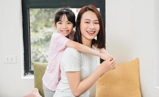 imagen de joven asiático madre y hija a hogar foto