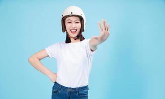 Young Asian woman wearing helmet on background photo