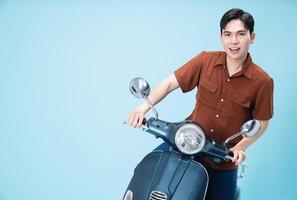 Image of yougn Asian man on motorbike photo