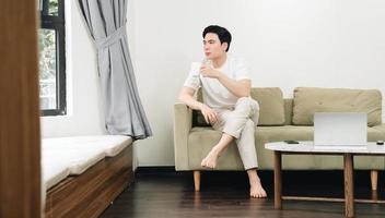 Image of young Asian man at home photo