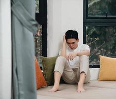 Image of young Asian man at home photo