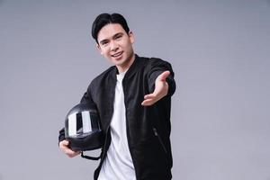 Image of young Asian man with helmet on background photo