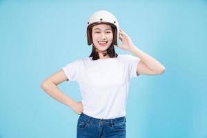 Young Asian woman wearing helmet on background photo