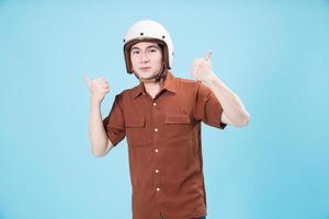 Young Asian man wearing helmet on background photo