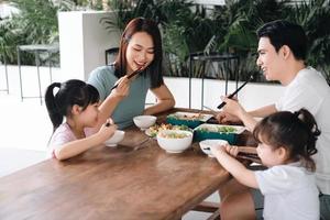 Image of Asian family eating lunch together photo