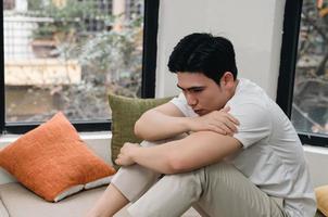 Image of young Asian man at home photo