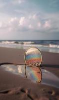 A Mirror On The Beach With The Sun Setting Behind It photo