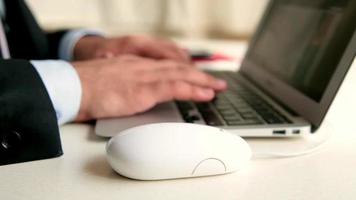 Businessman work with laptop in office, typing keyboard, click mouse, search data, selective focus, noise effect video