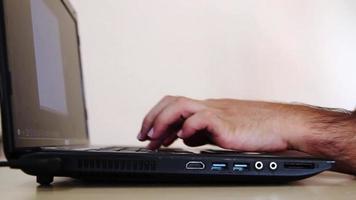 Hands typing on laptop, texting keyboard, search a data, selective focus, noise effect video