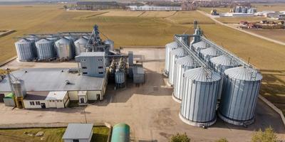 aerial panoramic view on silos and agro-industrial complex with grain drying line photo