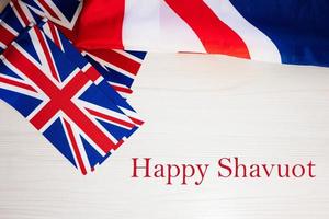 Happy Shavuot. British holidays concept. Holiday in United Kingdom. Great Britain flag background. photo