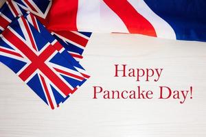 Happy Pancake Day. British holidays concept. Holiday in United Kingdom. Great Britain flag background. photo