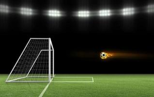 Soccer ball on fire is flying into the goal on the soccer field. ball game concept photo