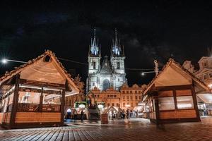 Prague old town square at night with a market in the cener of the city photo