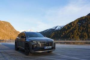 Car parked on road with mountain range in background photo