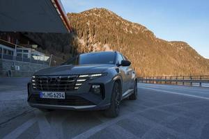 SUV car parked on road with mountains in background photo