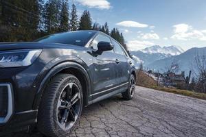 Car on road with mountain in background during winter trip photo