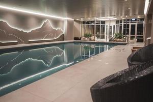 Interior of luxury hotel with swimming pool and decor photo