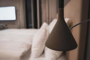 Interior of illuminated bedroom with bed in luxury hotel photo