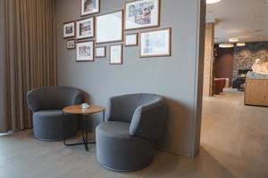 Empty chairs and picture frames in room of luxury hotel photo