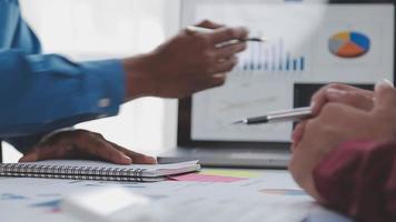Financial analysts analyze business financial reports on a digital tablet planning investment project during a discussion at a meeting of corporate showing the results of their successful teamwork. video