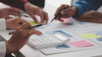 Financial analysts analyze business financial reports on a digital tablet planning investment project during a discussion at a meeting of corporate showing the results of their successful teamwork. video