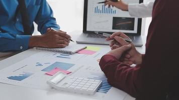 Financial analysts analyze business financial reports on a digital tablet planning investment project during a discussion at a meeting of corporate showing the results of their successful teamwork. video