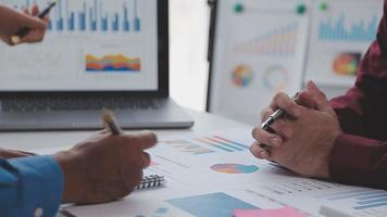 Financial analysts analyze business financial reports on a digital tablet planning investment project during a discussion at a meeting of corporate showing the results of their successful teamwork. video