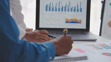 Financial analysts analyze business financial reports on a digital tablet planning investment project during a discussion at a meeting of corporate showing the results of their successful teamwork. video
