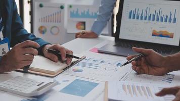 Financial analysts analyze business financial reports on a digital tablet planning investment project during a discussion at a meeting of corporate showing the results of their successful teamwork. video