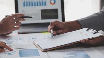 Financial analysts analyze business financial reports on a digital tablet planning investment project during a discussion at a meeting of corporate showing the results of their successful teamwork. video